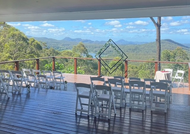 White Americana chairs set up for an outdoor wedding with a view in Brisbane