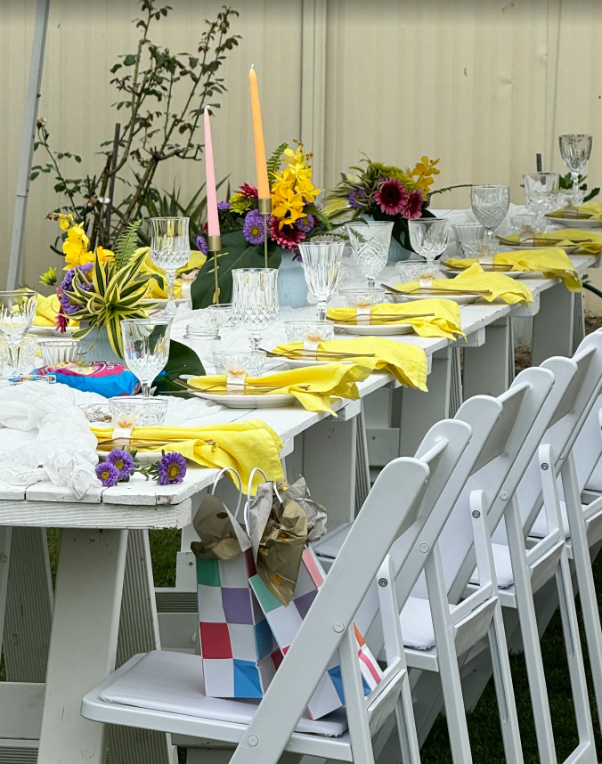 Tables with linen, chair covers and table decor set up for an event in Brisbane