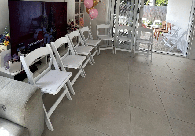 White Americana chairs set up for a baby shower in Brisbane